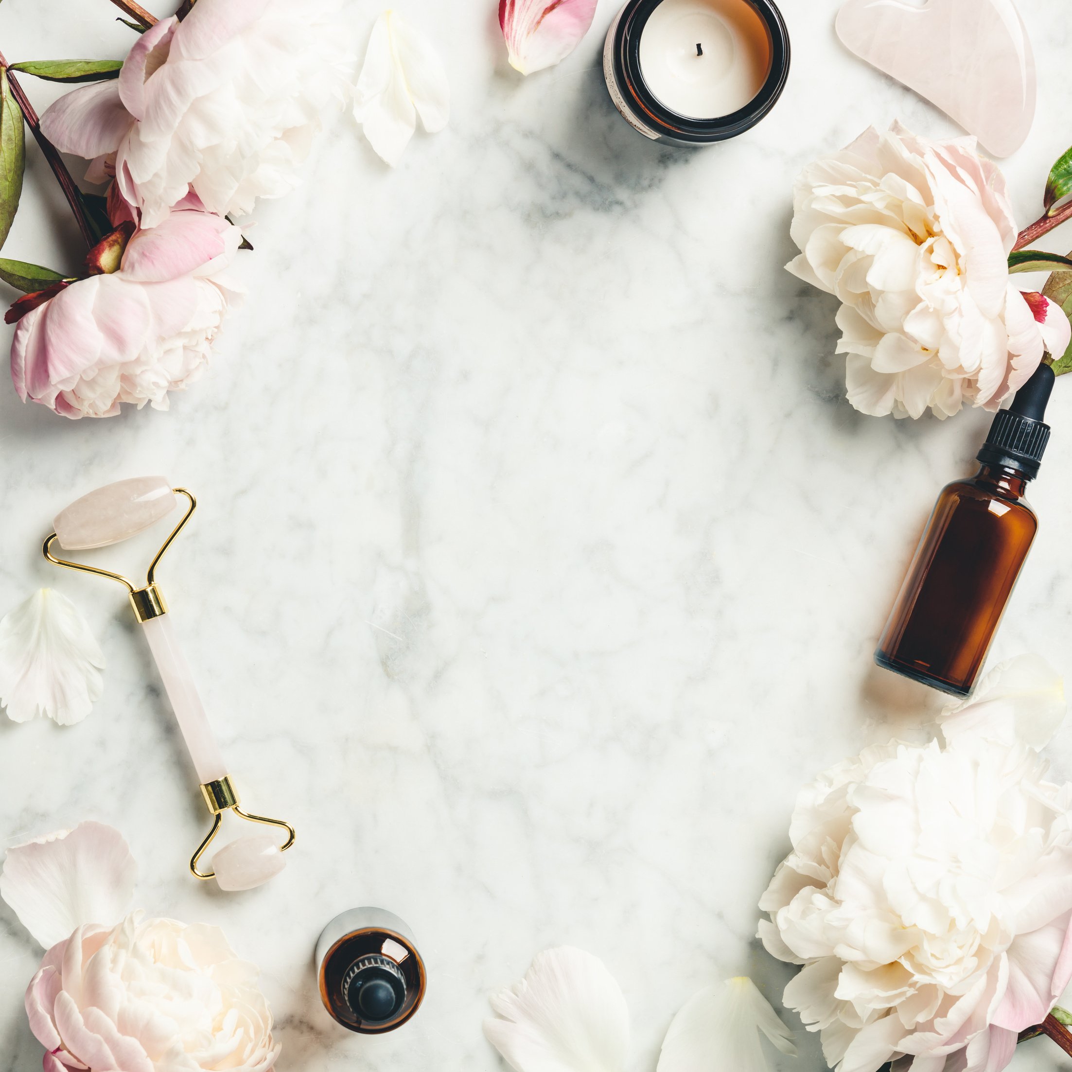 Facial Roller, Essential Oils, and Beautiful Peonies Flatlay